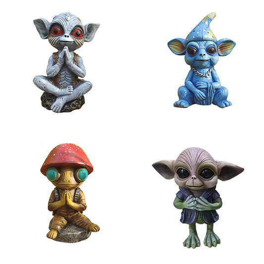 Four colorful alien figurines on a white background