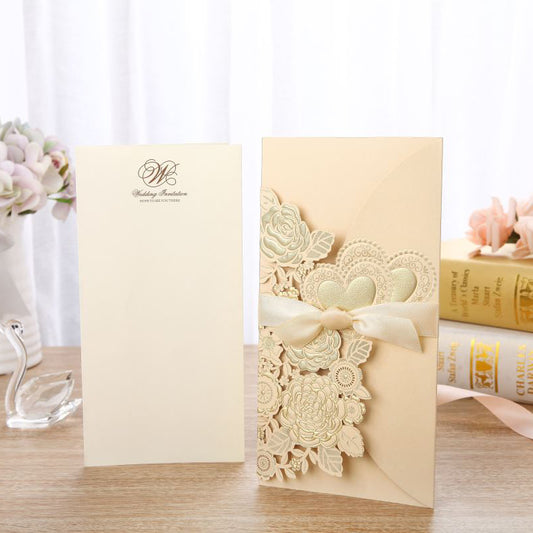Decorative card with floral design and ribbon on a wooden surface.