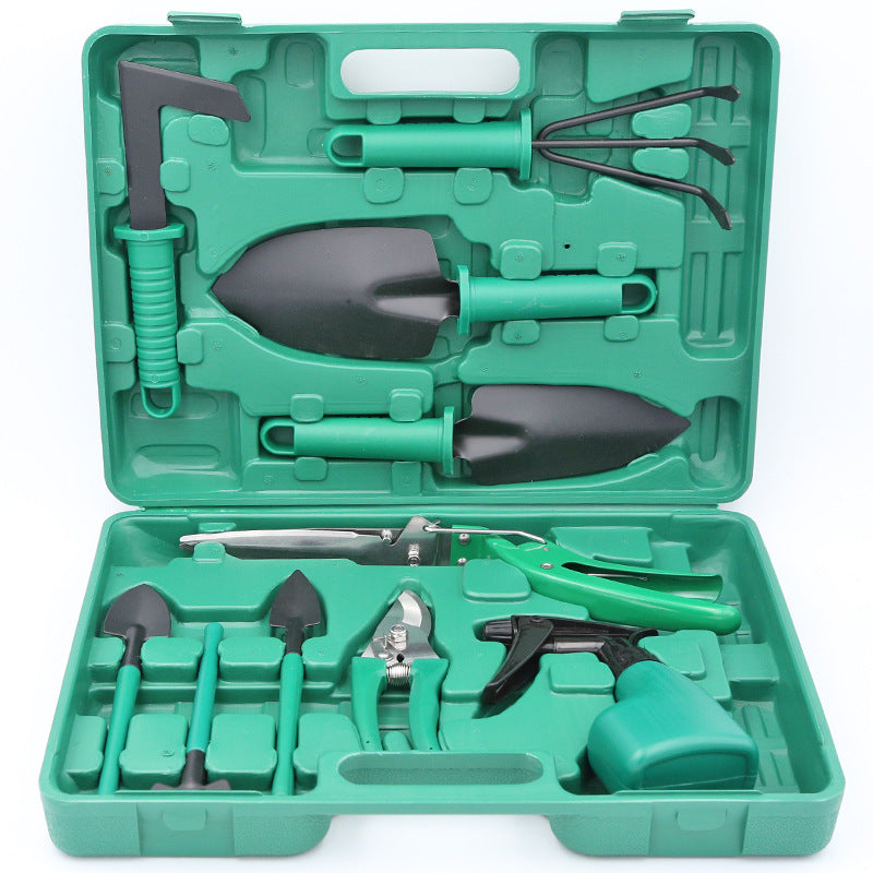 Set of gardening tools in a green case on a white background