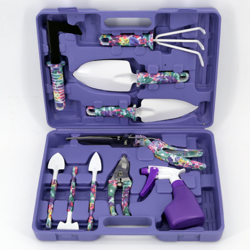 Gardening tool set with floral handles in a purple case on a white background