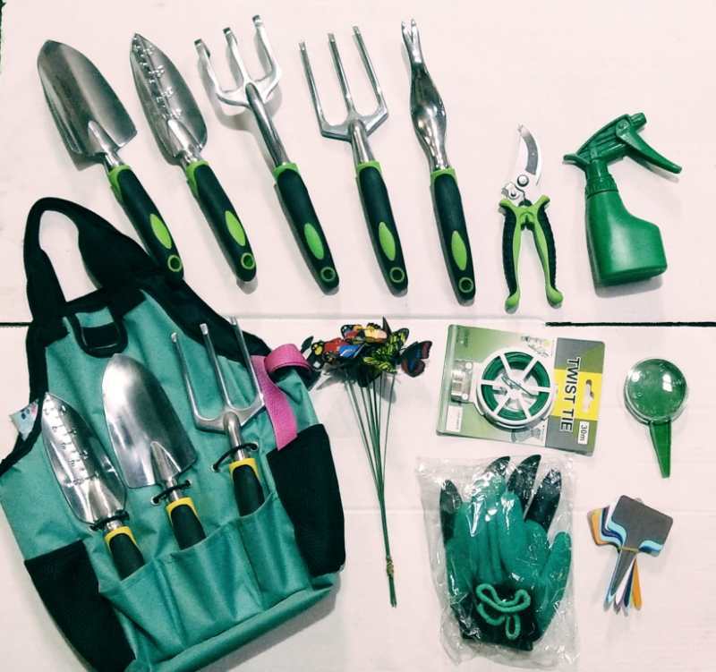 Gardening tools including shovels, forks, pruners, a spray bottle, and gloves on a white background.