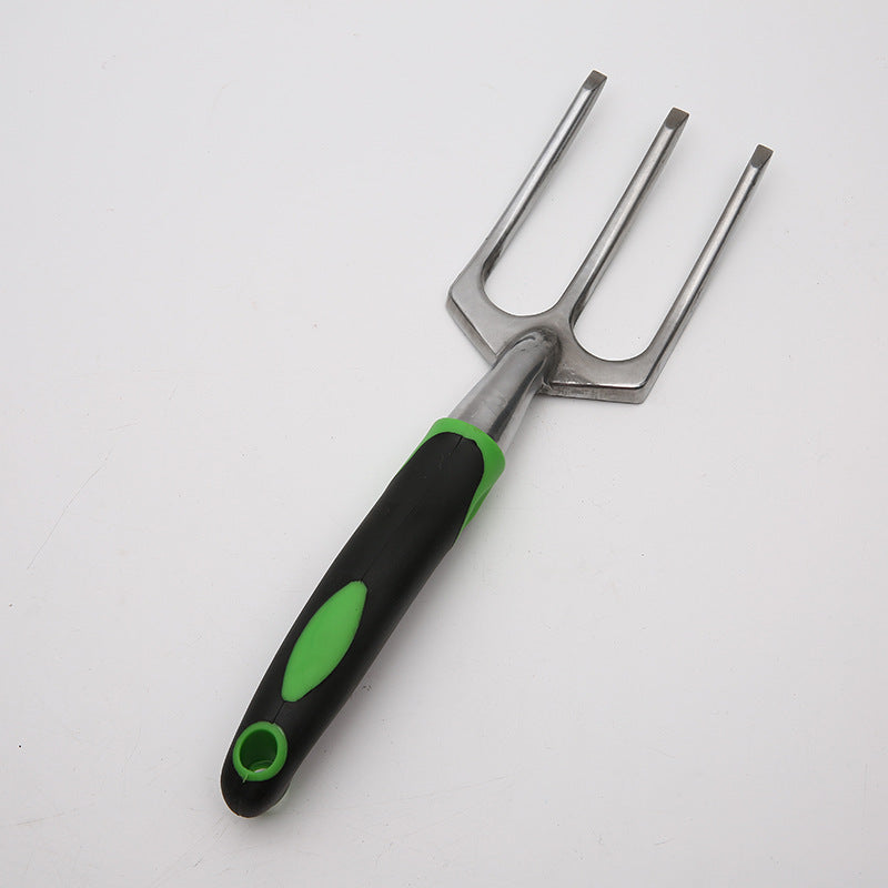 Gardening tool with black and green handle on a white background