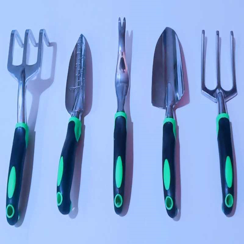 Set of gardening tools with green handles on a white background