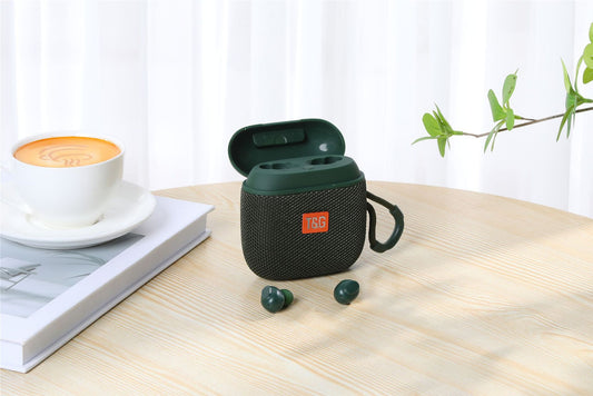 Green wireless earbuds case with JBL logo on a wooden table with a cup of coffee and book in the background.