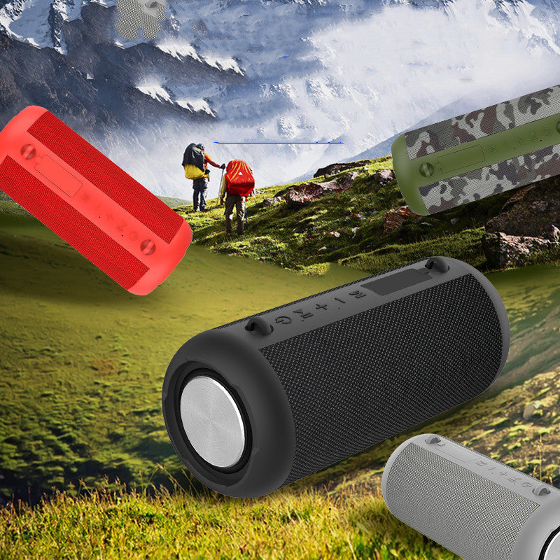 Black portable speaker with red, green, and gray options on a mountain background