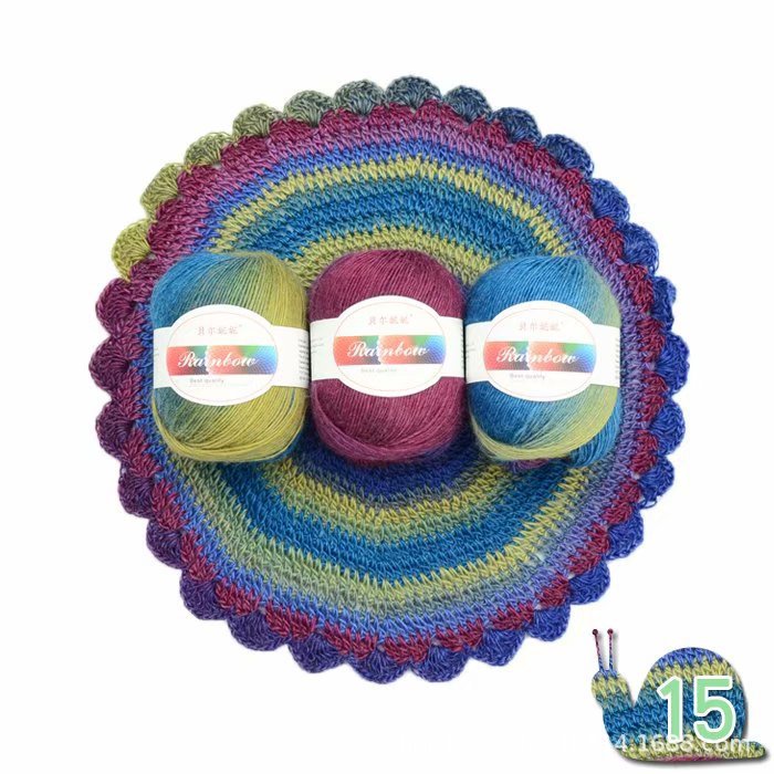Three balls of yarn with labels on a colorful crocheted dish, featuring a snail with the number 15.