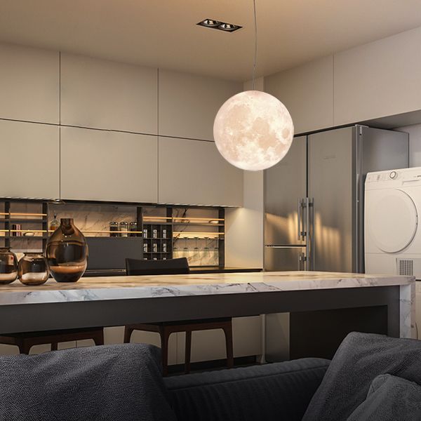 Modern kitchen with marble countertop, pendant light, and stainless steel appliances.