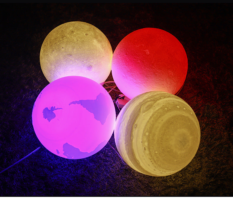 Four colorful moon-shaped lamps on a dark background