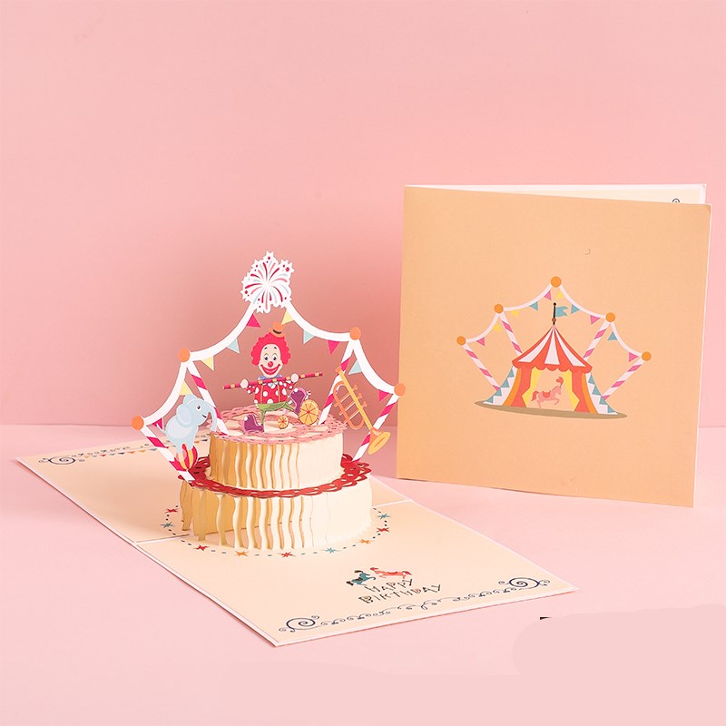 Pop-up card with a clown and cake design on a pink background