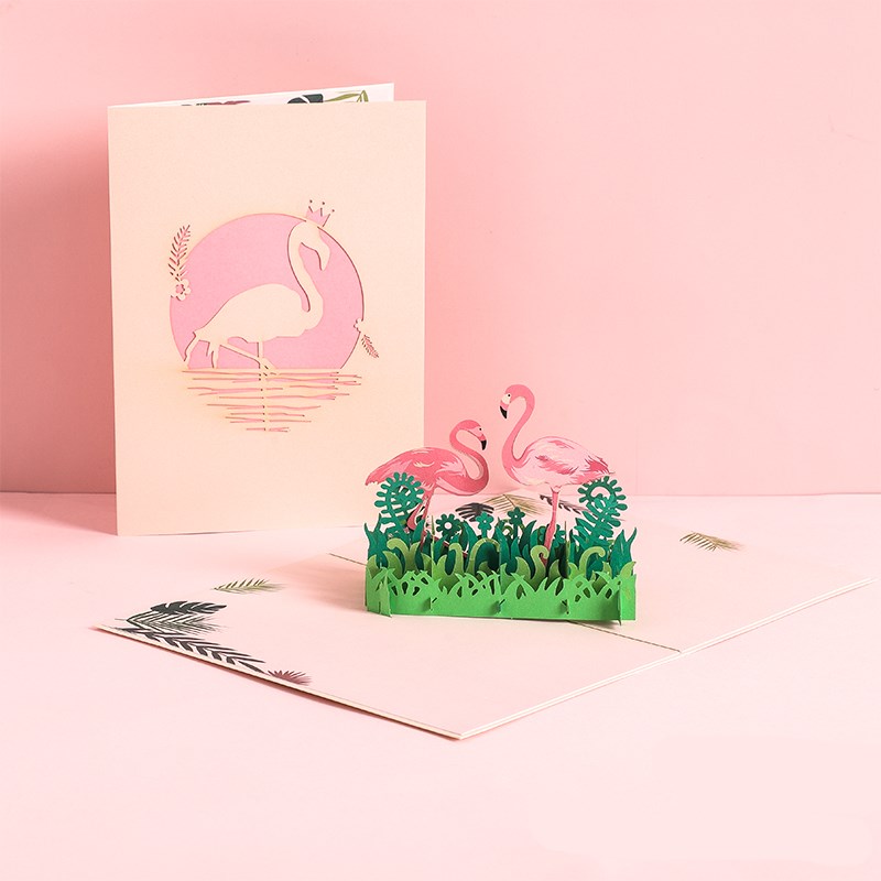 Greeting card with 3D flamingo design on a pink background