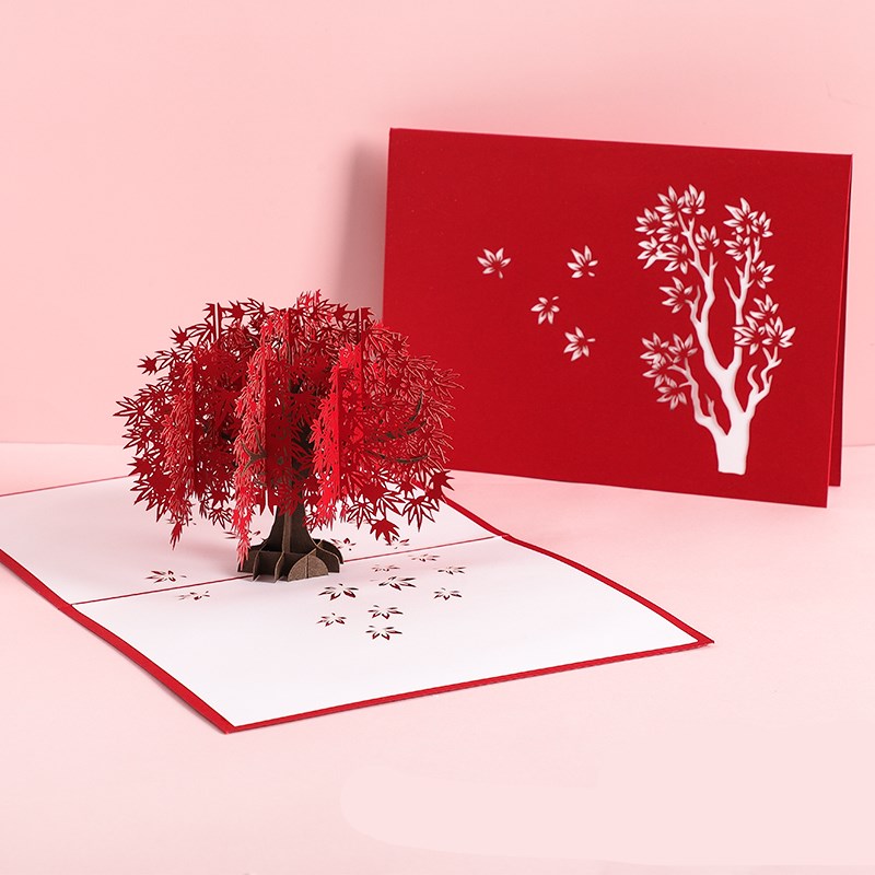Pop-up card with a red tree and white flowers on a pink background