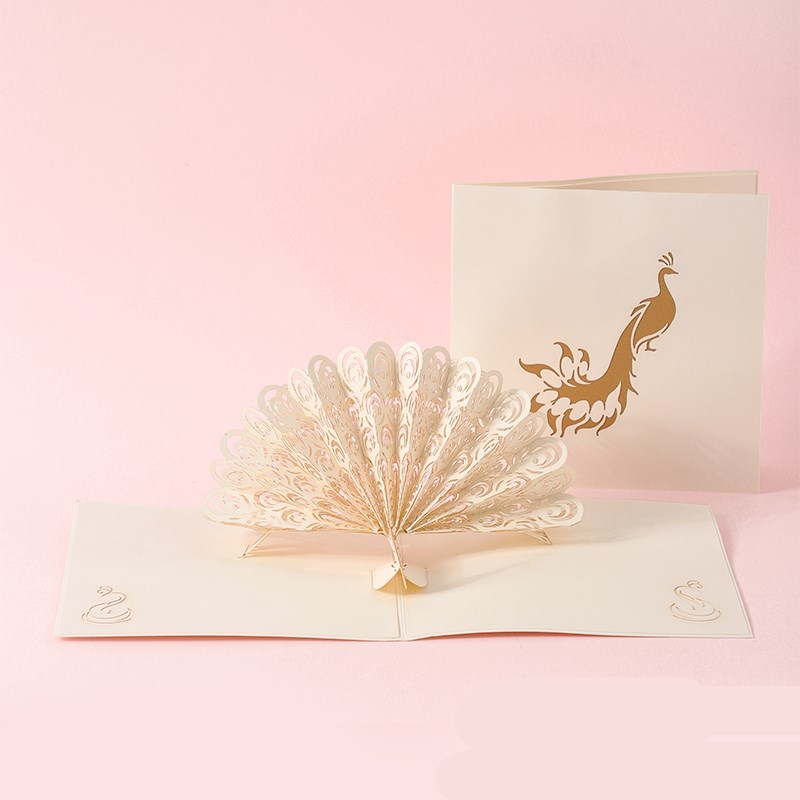 Pop-up card with peacock design on a pink background