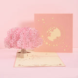 Pop-up card with cherry blossom tree and moon design on a pink background