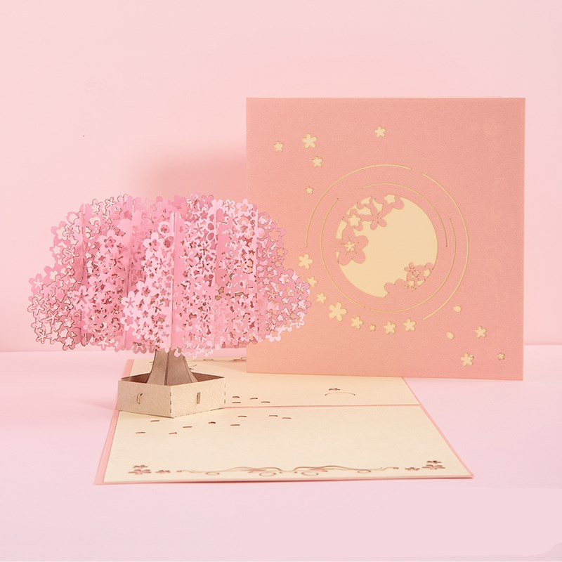 Pop-up card with cherry blossom tree and moon design on a pink background