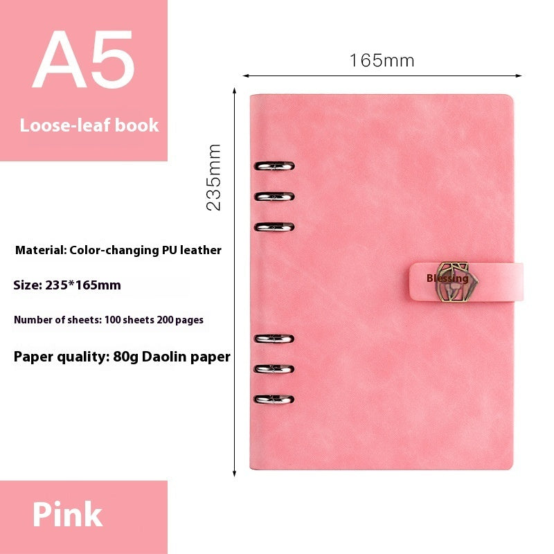 Pink loose-leaf book with dimensions and material details on a white background