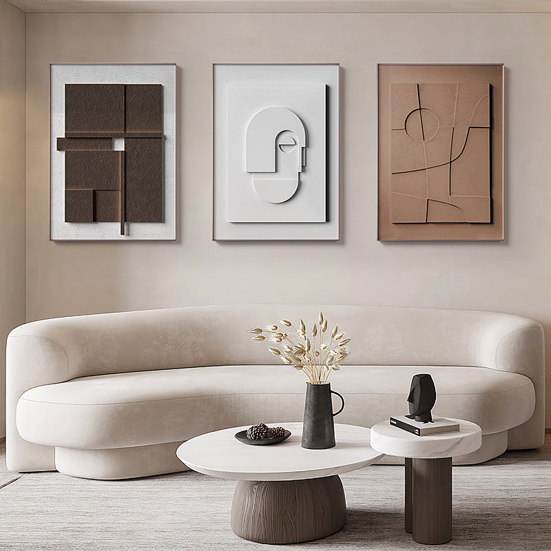 Modern living room with a beige sofa, abstract art, and decorative items.