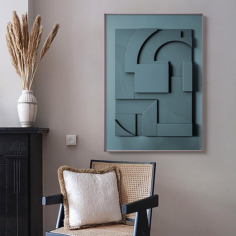Abstract wall art piece on a gray wall with a chair and decorative elements.