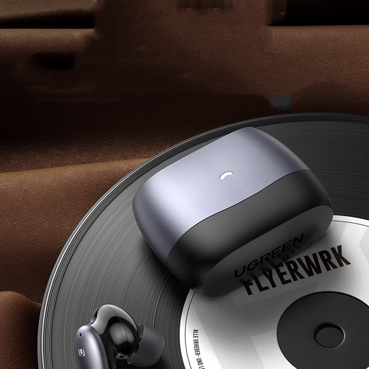 Wireless earbuds on a vinyl record with 'UGREEN FLYERWRK' branding.
