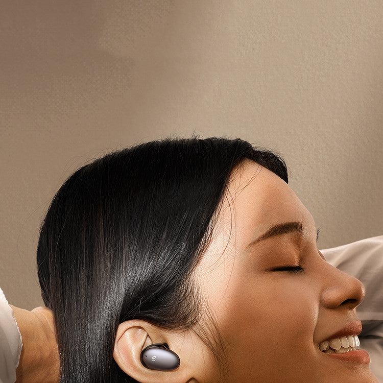 Woman wearing wireless earbuds with a neutral background