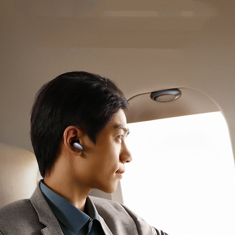 Man wearing wireless earbuds inside a vehicle