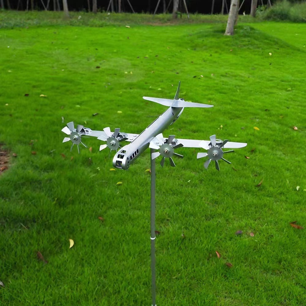 Model airplane on a stand in a grassy outdoor setting
