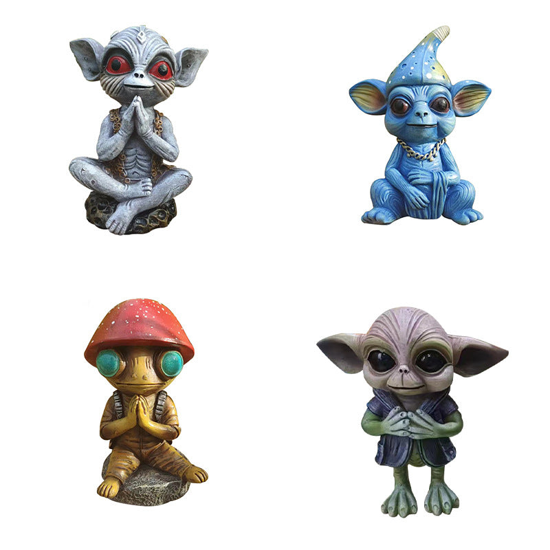 Four colorful alien figurines on a white background