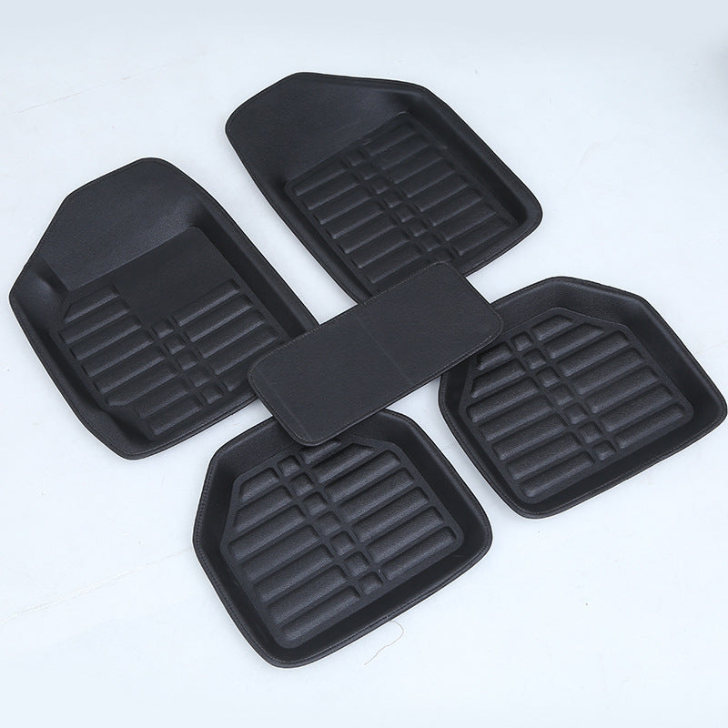 Black heavy-duty rubber car mats with deep channels for trapping dirt, mud, and water in vehicle footwells