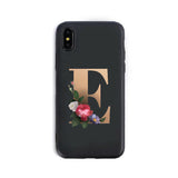 Phone case with letter 'E' and floral design on a black background