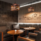 Cozy restaurant interior with wooden tables, chairs, and decorative wall art.