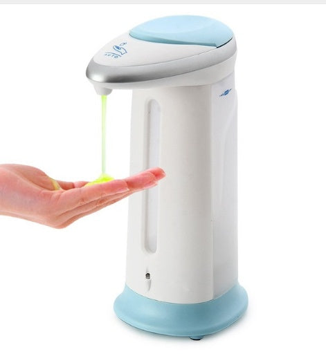 Hand pressing a soap dispenser with a white and blue design on a white background