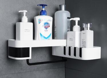 Bathroom shelf with various bottles and containers against a gray wall.