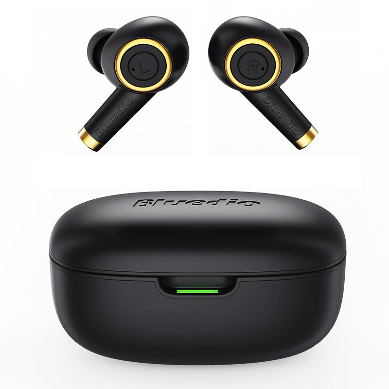 Black wireless earbuds with gold accents and a black case on a white background