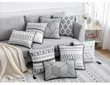 Gray sofa with patterned cushions in a living room setting
