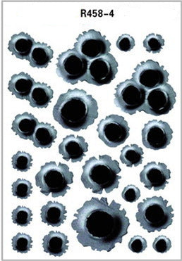 Sheet of bullet hole decals with various sizes on a white background