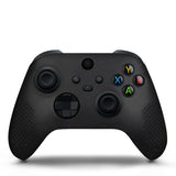 Black gaming controller on a white background