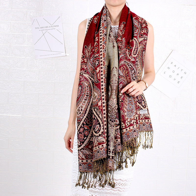 Person wearing a patterned scarf on a white background