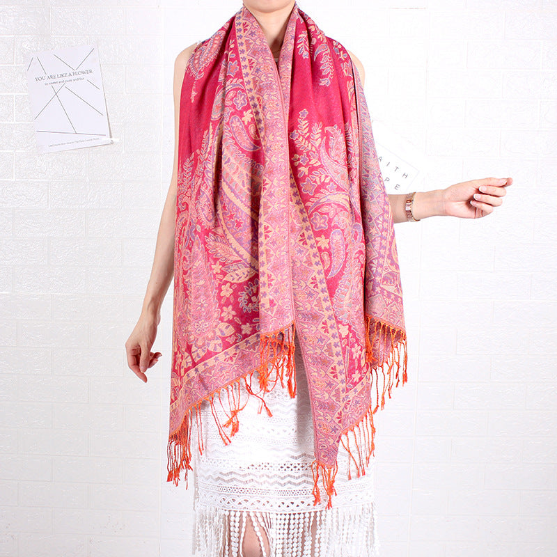 Person wearing a pink and orange patterned scarf on a white background