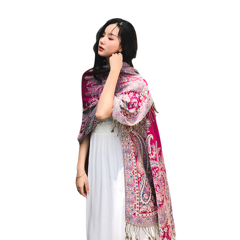 Woman wearing a colorful patterned scarf on a white background