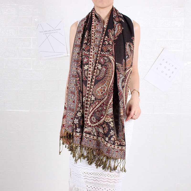 Person wearing a patterned scarf on a white background