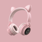 Pink headphones with cat ears on a pink background