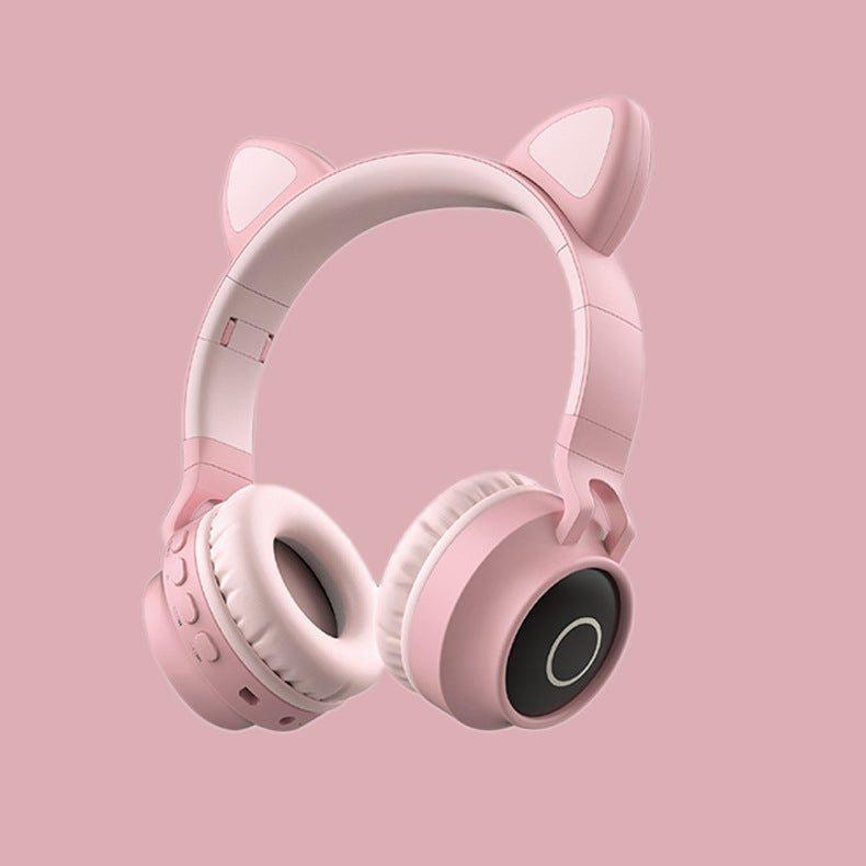 Pink headphones with cat ears on a pink background