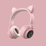 Pink headphones with cat ears on a pink background