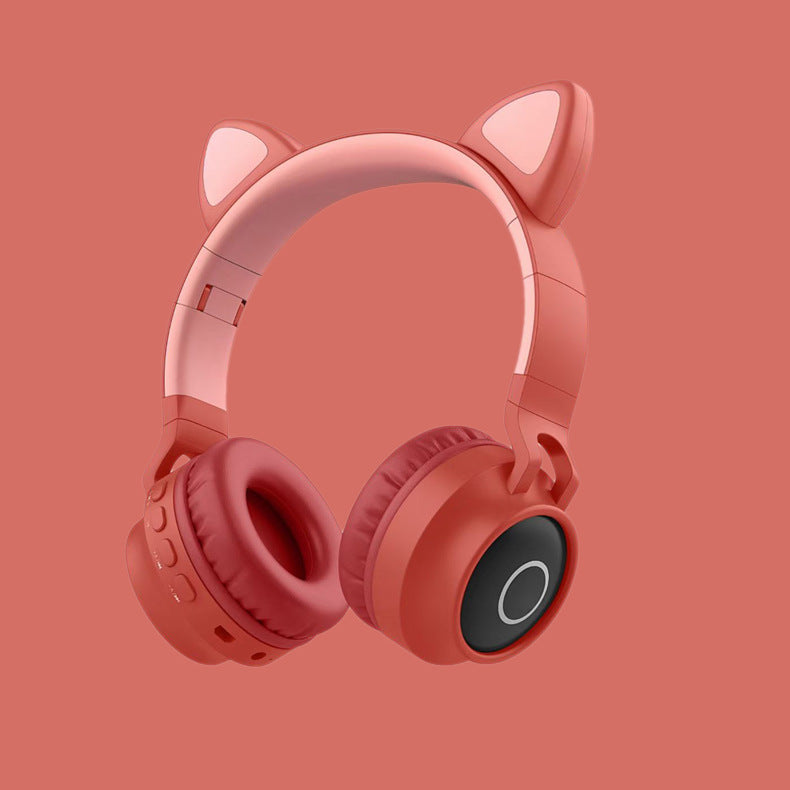 Pink headphones with cat ears on a red background