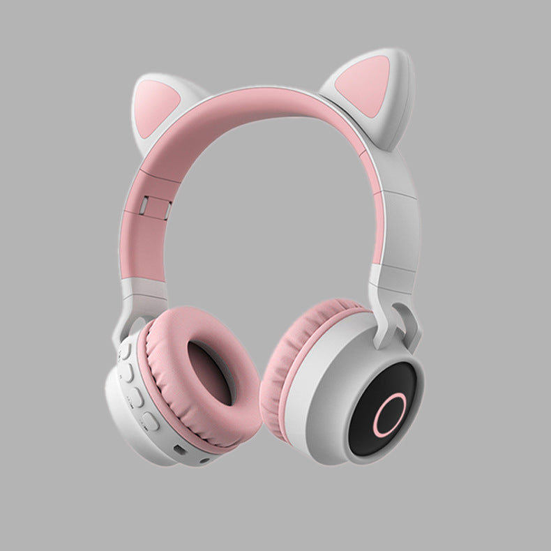 Pink and white headphones with cat ear design on a gray background