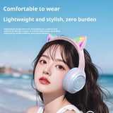 Person wearing cat ear headphones with a scenic background