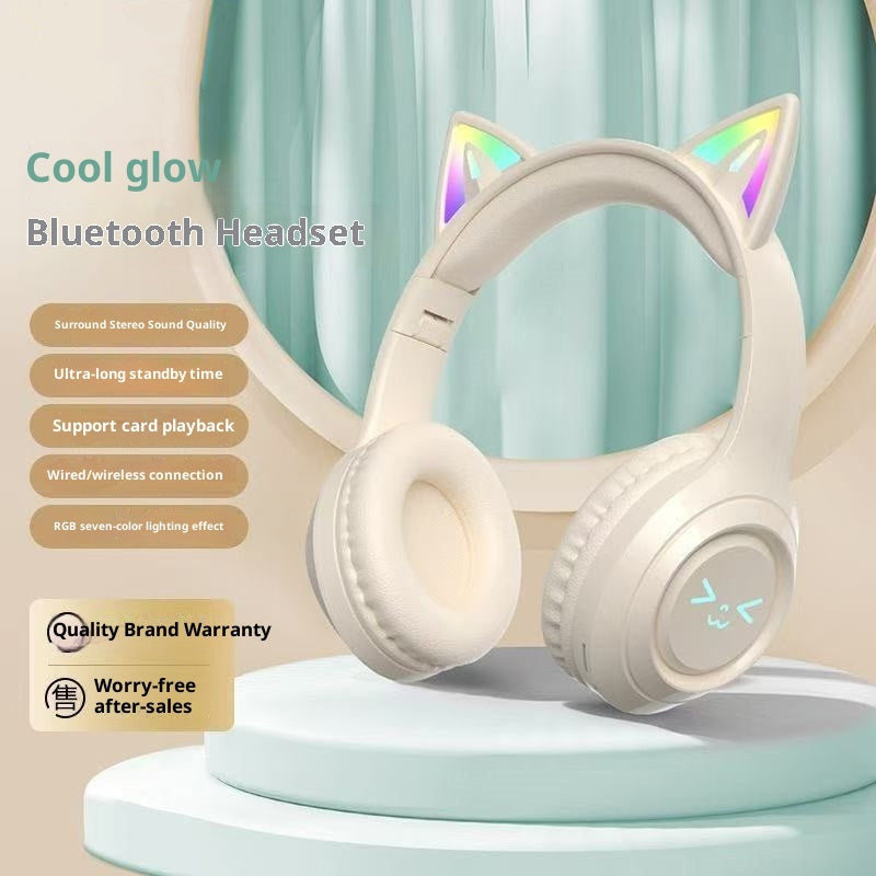Cat ear Bluetooth headset with RGB lighting on a stand against a light blue curtain background