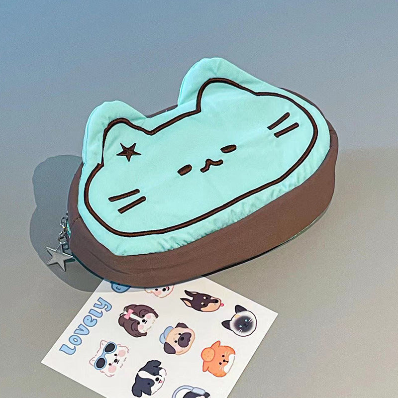 Cute cat-shaped pencil case with a set of stickers on a gray surface