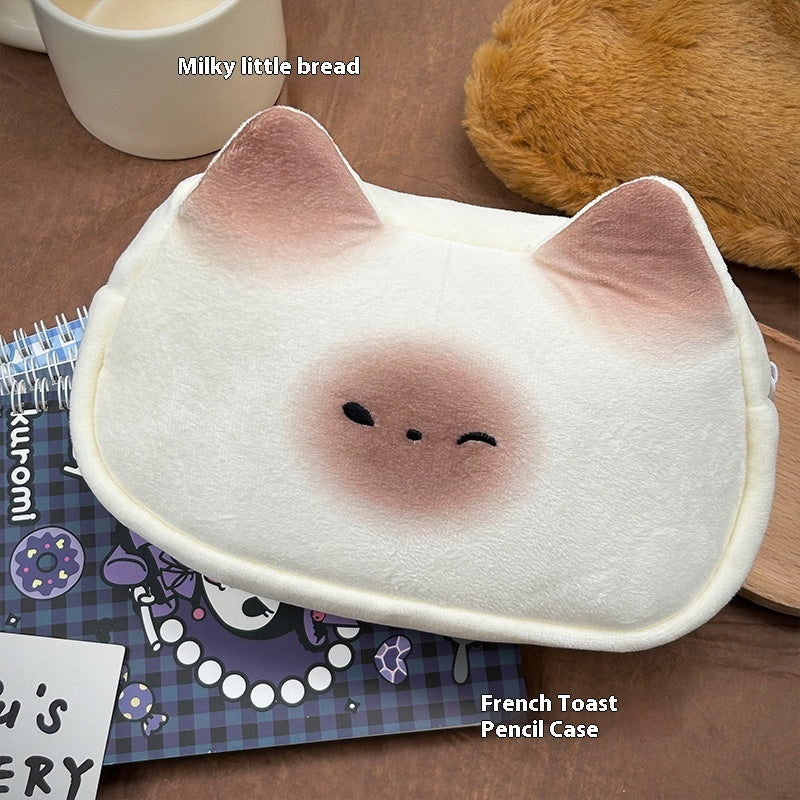 Kawaii-style pencil case shaped like a cat with a face, on a wooden surface.