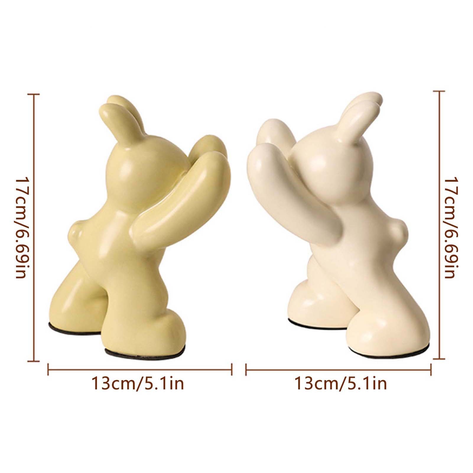 Two ceramic figures with dimensions indicated on a white background