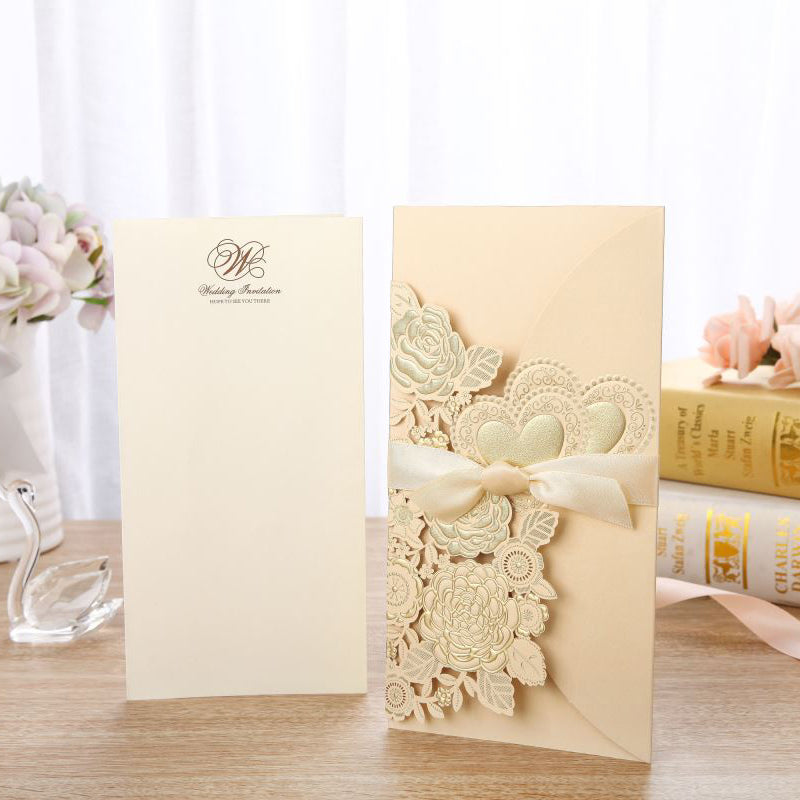 Decorative card with floral design and ribbon on a wooden surface.